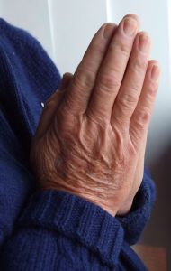 A photo of hands together for prayer